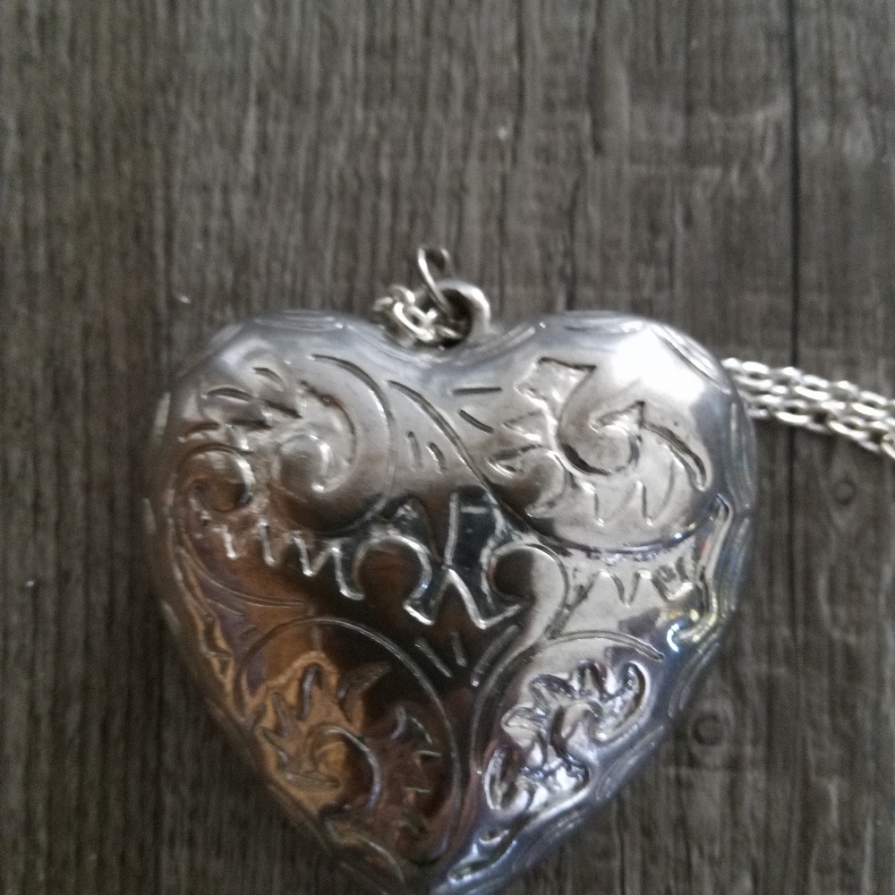 Oversized heart. Silvertone. 2"heart with 15" chain. $16.00